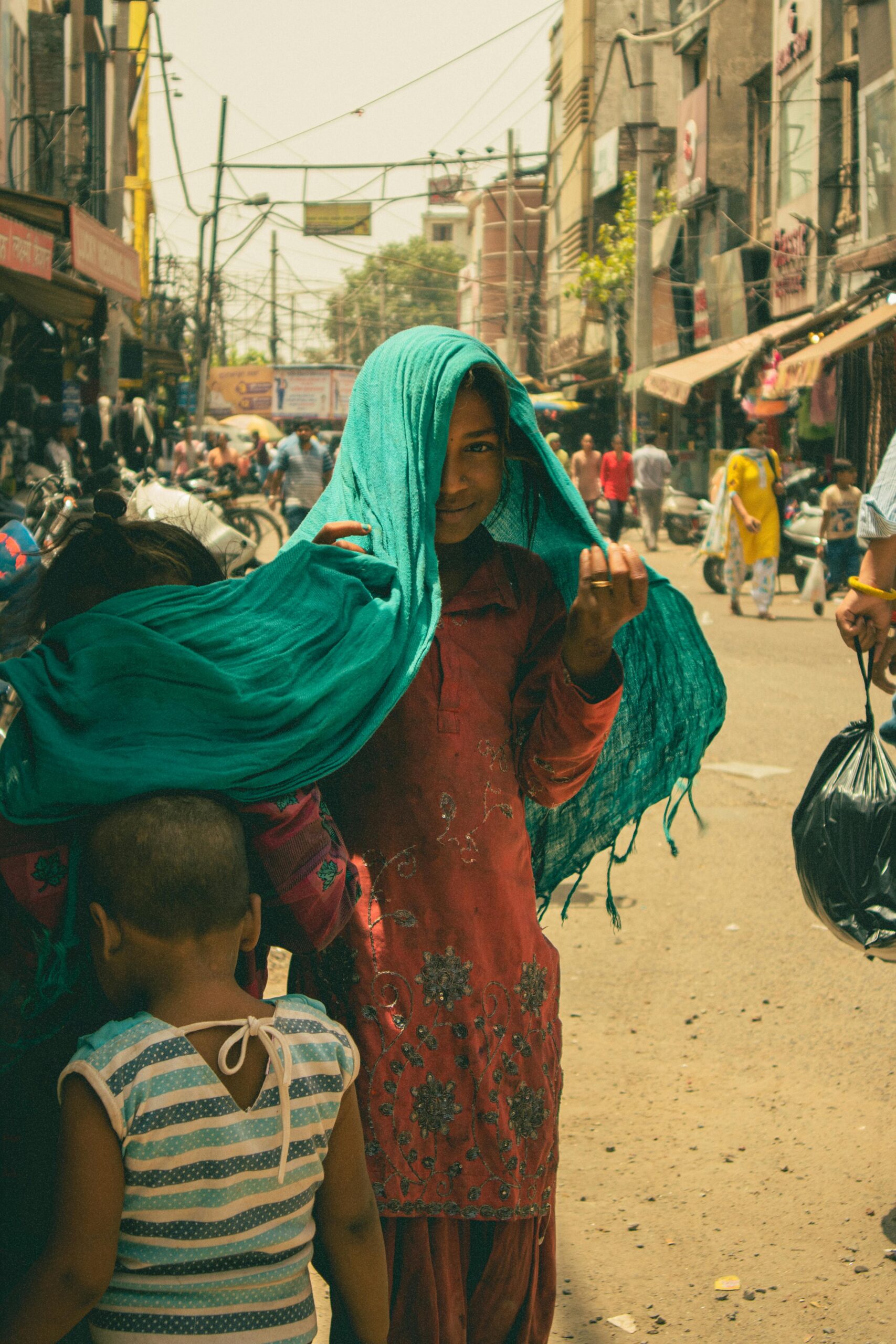 Girl Standing in Shawl on Street
